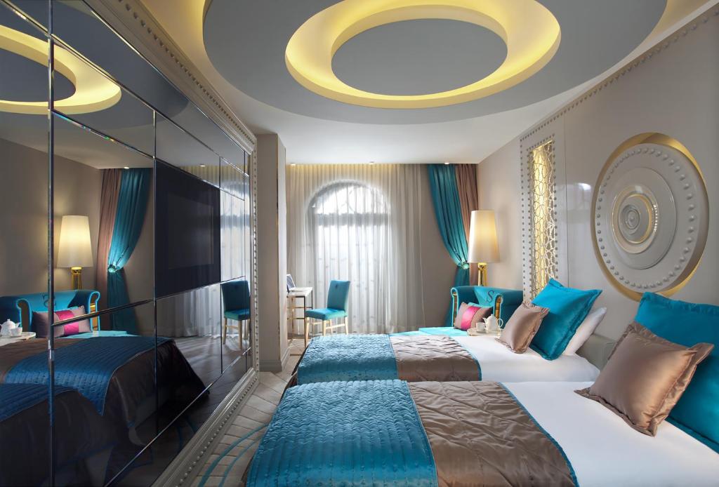 A bed or beds in a room at Sura Design Hotel & Suites