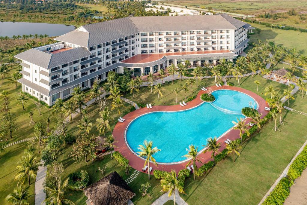 an aerial view of a resort with a swimming pool at Melia Vinpearl Cua Hoi Beach Resort in Cửa Lò