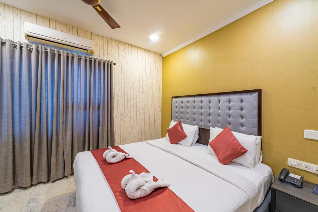 a bedroom with two beds with towels at Luxury Suites by Athome in Kondapur