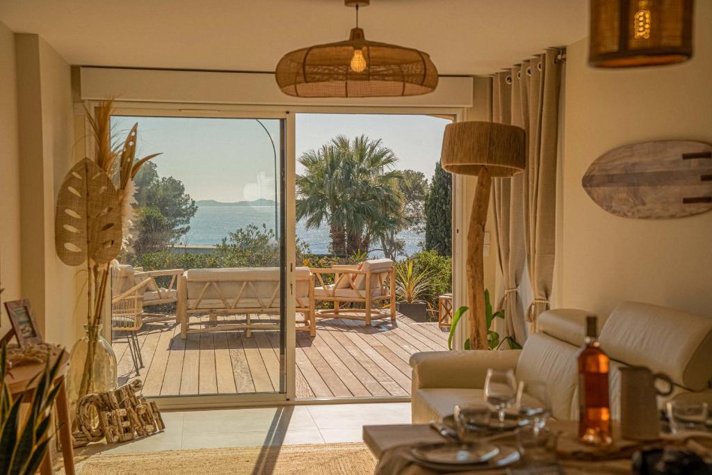 a living room with a view of the ocean at Logement vue mer splendide - situé à 50 mètres du bord de mer et 2 minutes des plages - Bandolina in Bandol