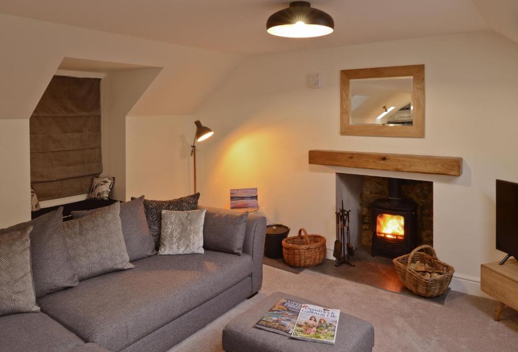 a living room with a couch and a fireplace at Stroan in New Galloway