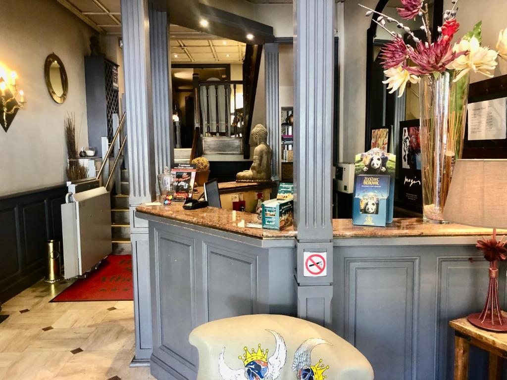 a blue counter in a store with a chair at Hôtel Saint Albert in Sarlat-la-Canéda