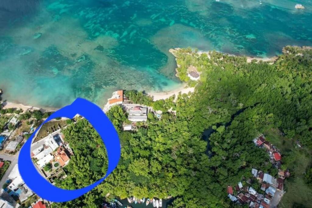 an aerial view of an island with a blue circle at Relax in front of beach! 3 bd condo with rooftop! in Río San Juan