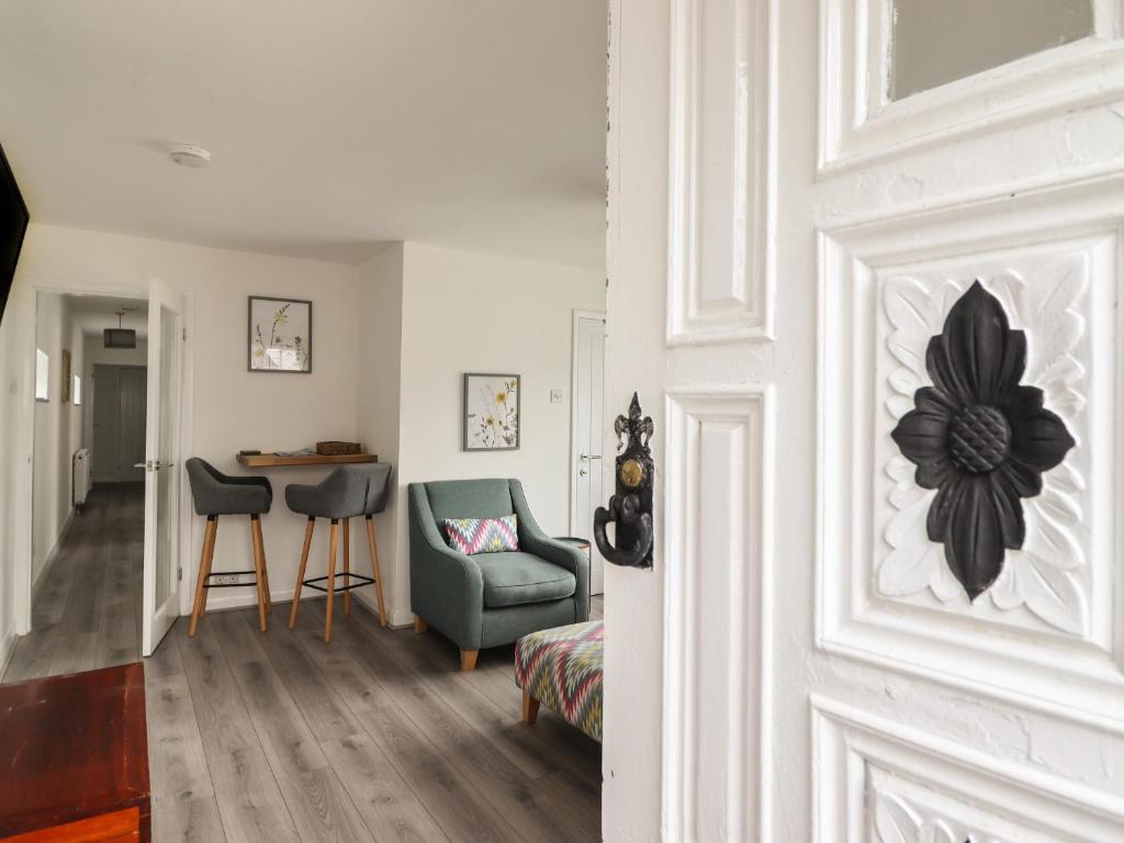 a room with a door with a chair and a table at The Old Coach House in Conwy