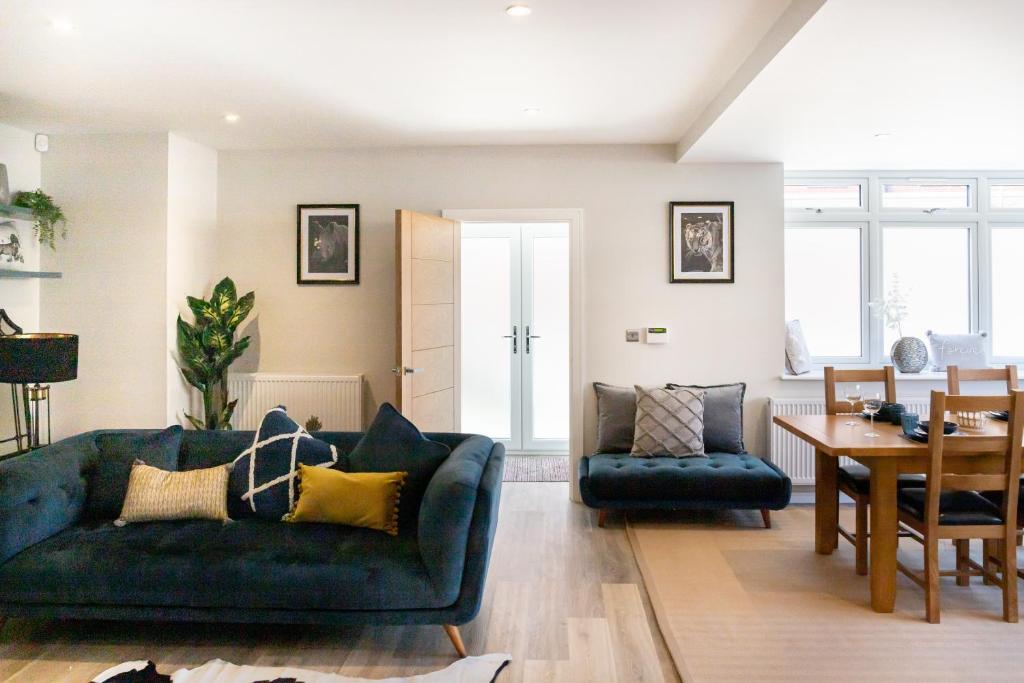 a living room with a couch and a table at Amazing New Spacious Apartment in SE1 in London