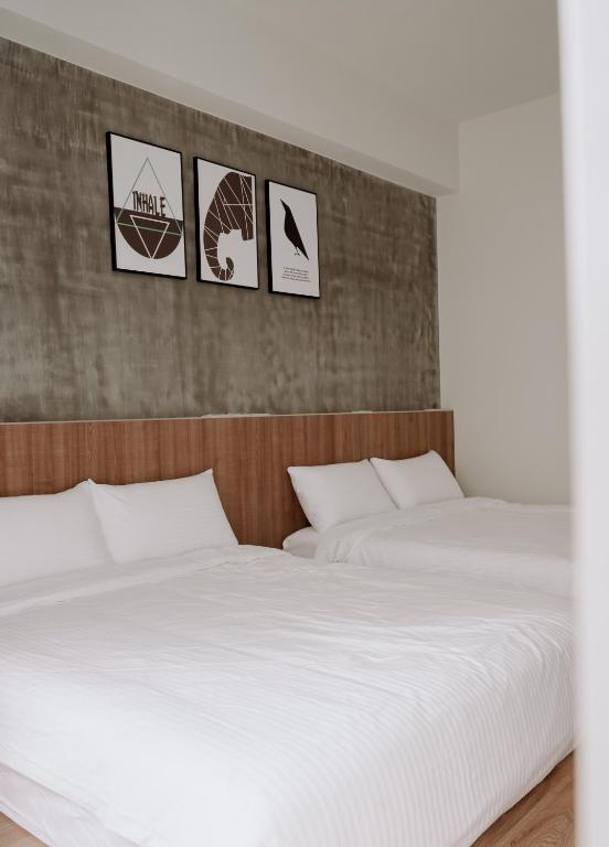 Postel nebo postele na pokoji v ubytování Huiwei B&B