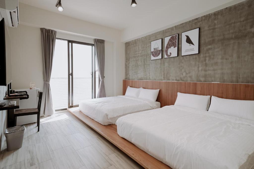 Postel nebo postele na pokoji v ubytování Huiwei B&B