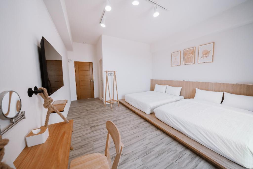 Postel nebo postele na pokoji v ubytování Huiwei B&B