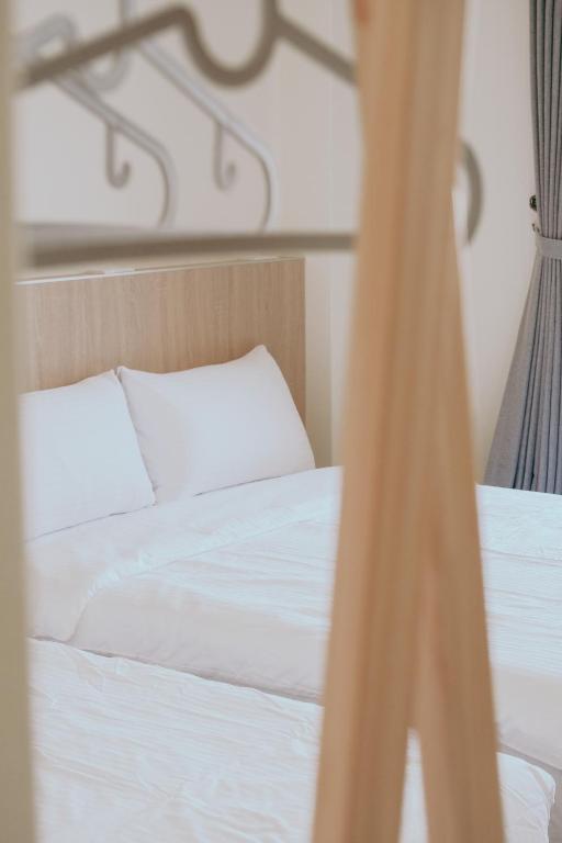 Postel nebo postele na pokoji v ubytování Huiwei B&B