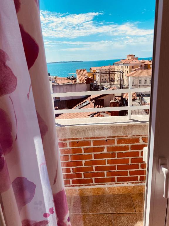 a view of the ocean from a balcony at ReginaMare Santa in Piran