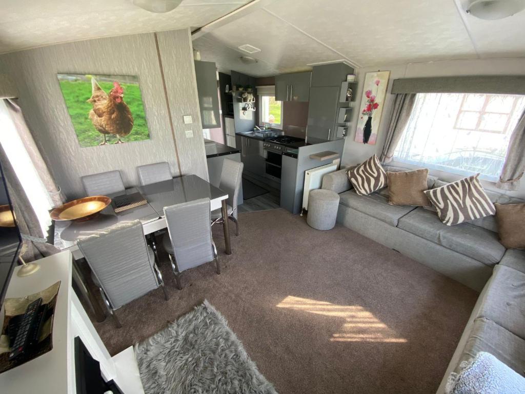 an aerial view of a living room and kitchen in a tiny house at Superb luxury two bed caravan, Todber Valley Holiday Park, sleeps six in Gisburn