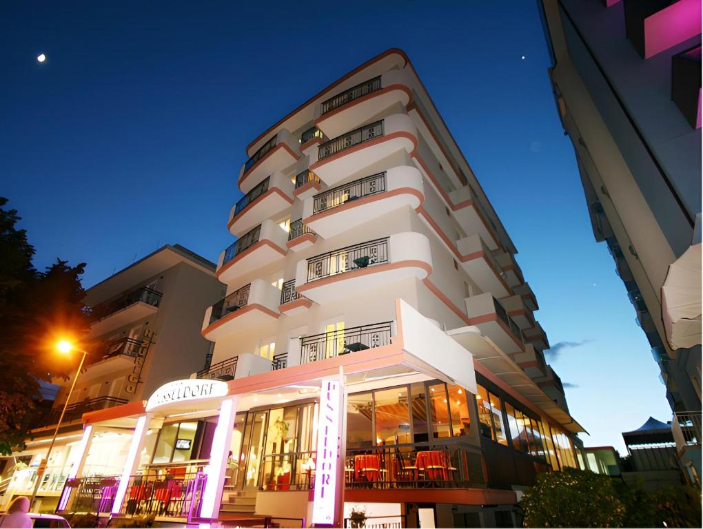 a tall white building with a lot of windows at Hotel Dusseldorf in Rimini