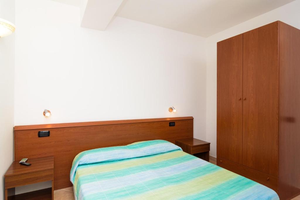 Postel nebo postele na pokoji v ubytování Hotel Villa Fumerie