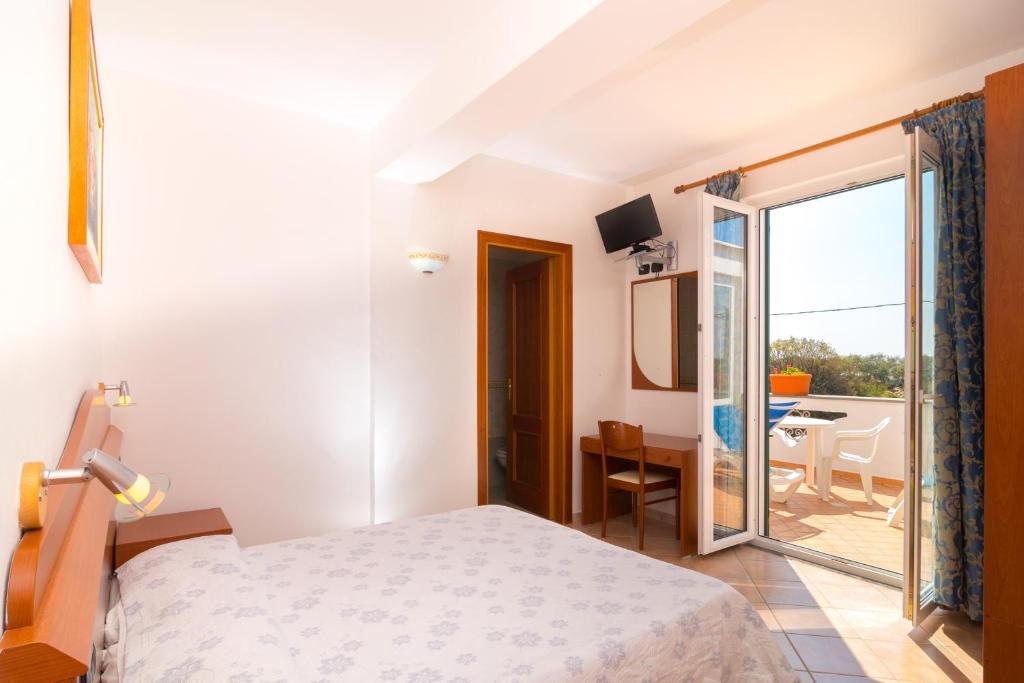 Postel nebo postele na pokoji v ubytování Hotel Villa Fumerie