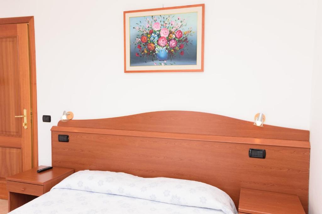 Postel nebo postele na pokoji v ubytování Hotel Villa Fumerie