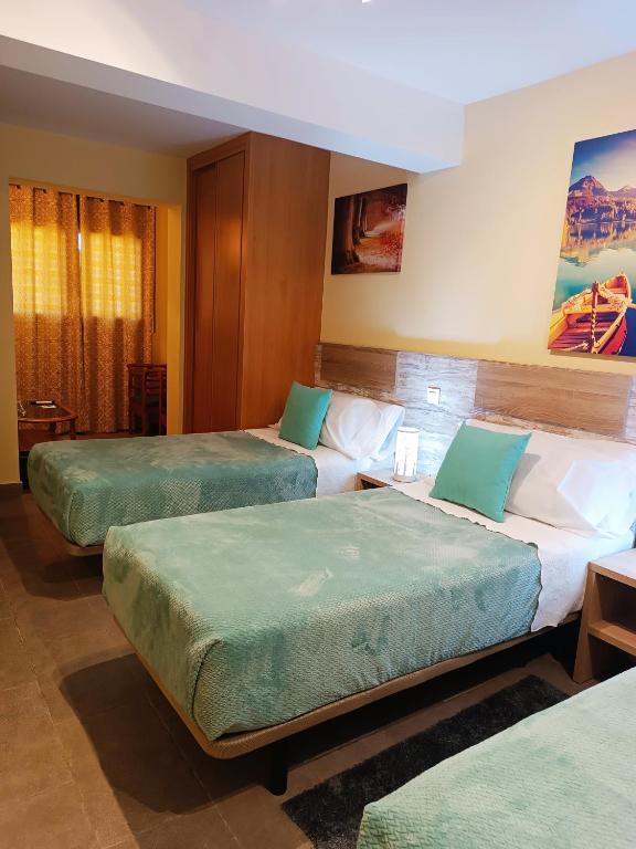 Postel nebo postele na pokoji v ubytování Hotel Alma Rosa