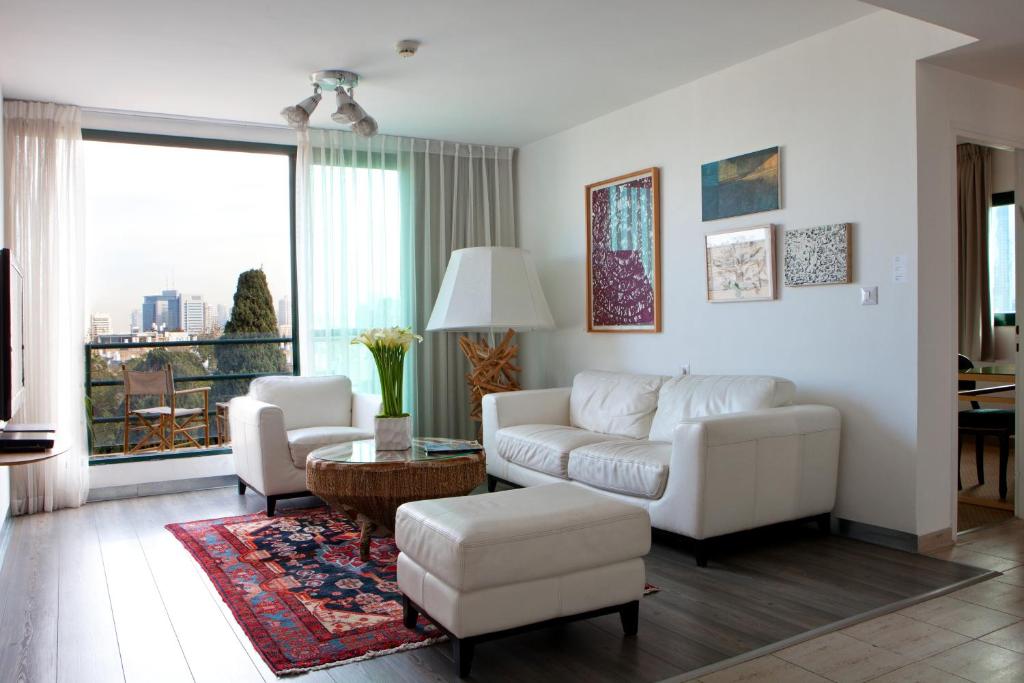 
a living room filled with furniture and a window at Diaghilev LOFT live art hotel in Tel Aviv
