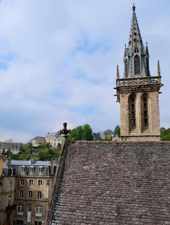 a clock tower on top of a building with a roof at Contes à Rebours - Chambres d&#39;hôtes in Morlaix