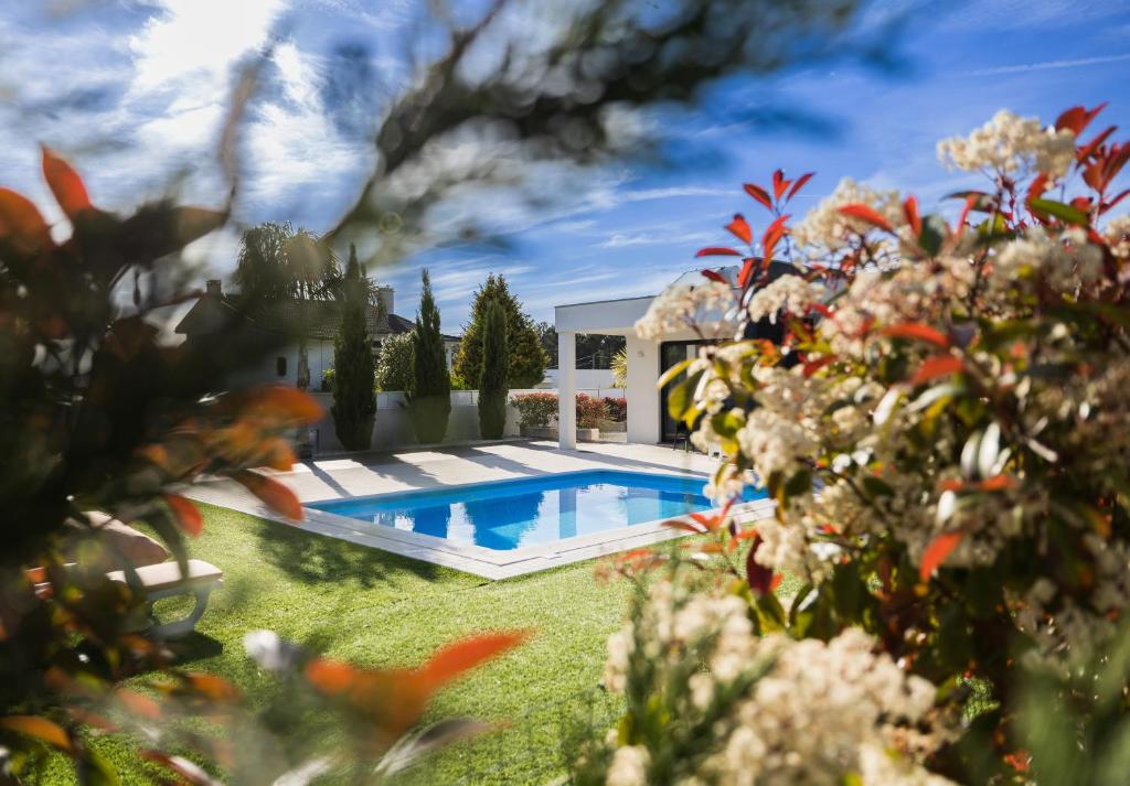 a swimming pool in the yard of a house at Meirinha House in Viana do Castelo