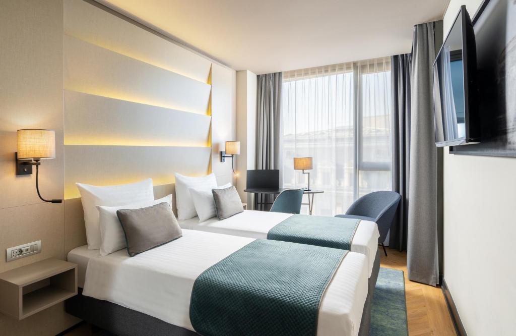 Postel nebo postele na pokoji v ubytování Leonardo Hotel Bucharest City Center