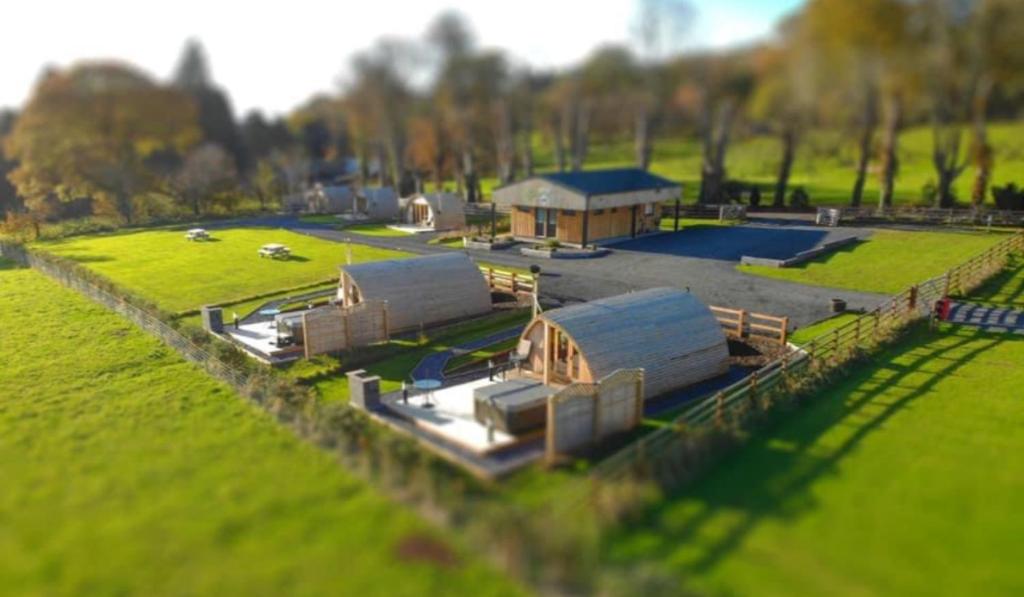 an aerial view of a farm with tents in a field at 68 Degrees West Glamping in Brecon