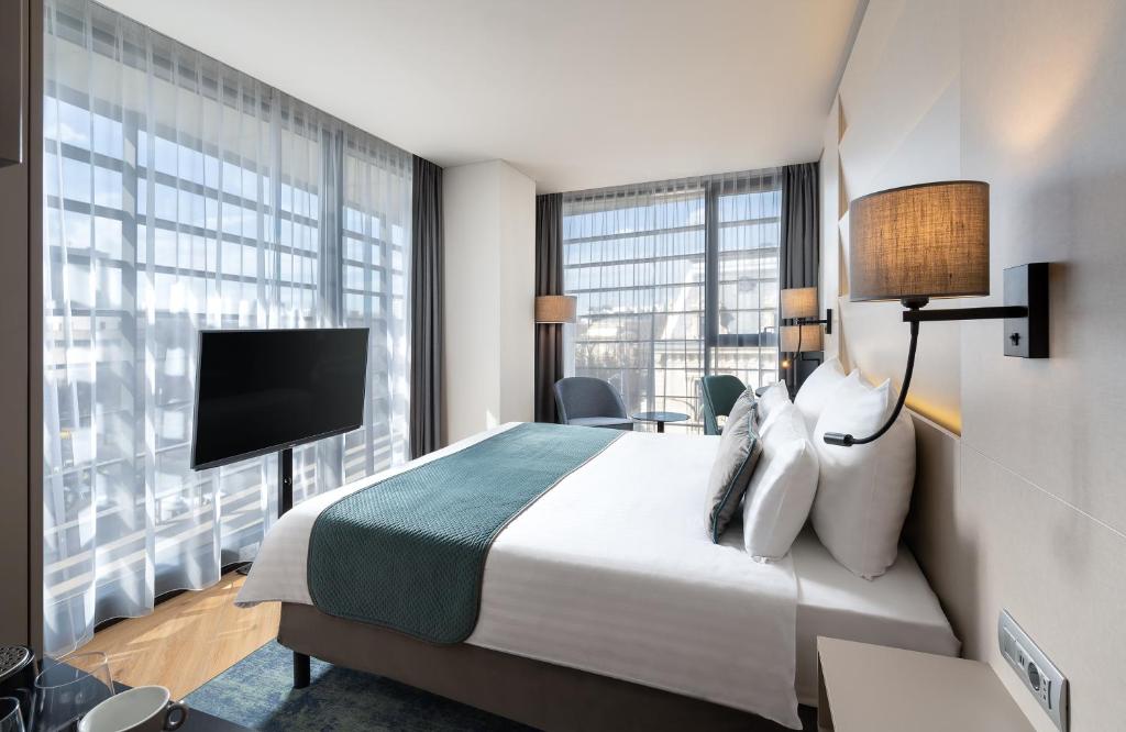 Postel nebo postele na pokoji v ubytování Leonardo Hotel Bucharest City Center