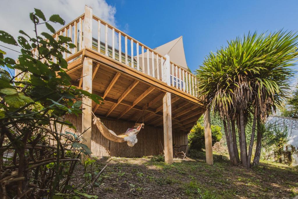 a wooden house with a staircase on top of it at Glastonbury, large House Stunning views 2 to 5 bedrooms, 3 receptions turn into bedrooms in Glastonbury