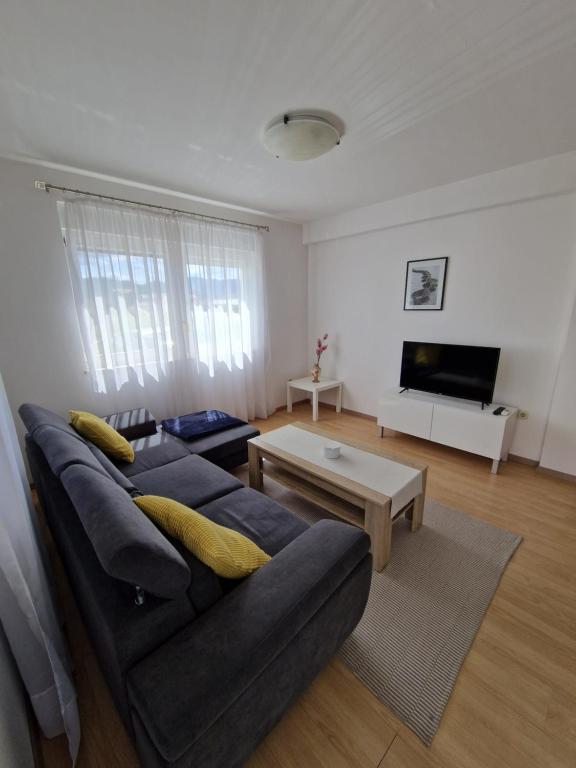 a living room with a couch and a coffee table at Apartment Melody in Metković