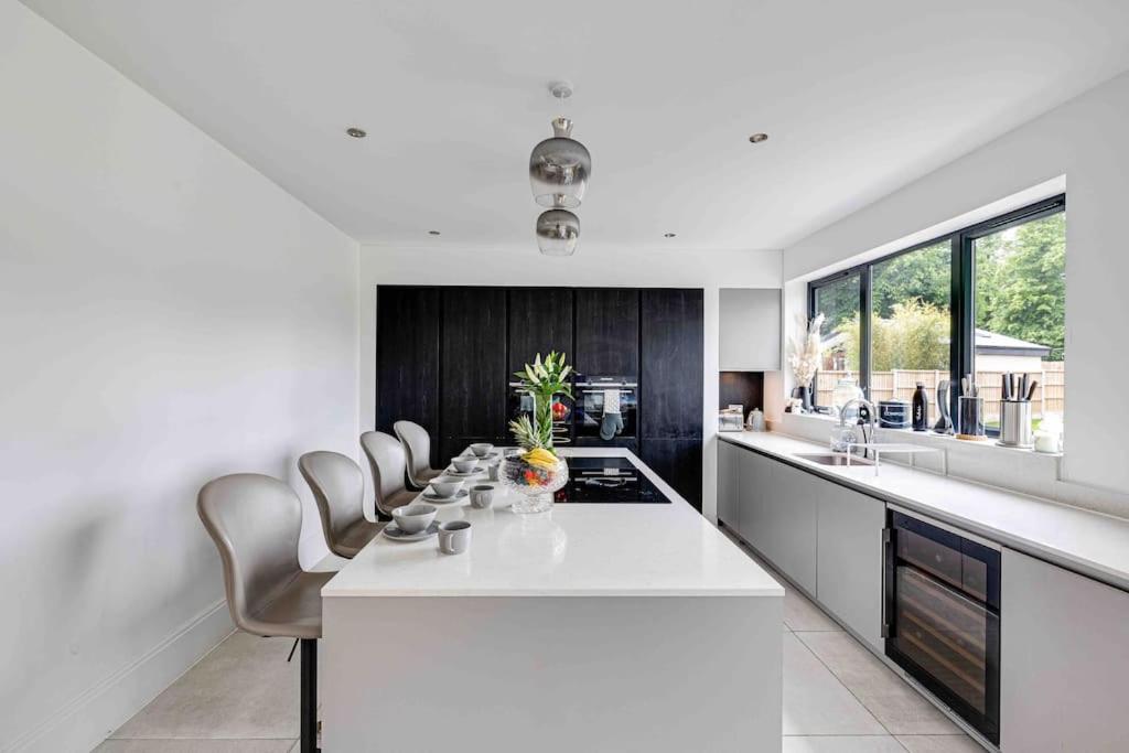 a kitchen with a white counter and chairs in it at 8986690/2023 in Birkenhead