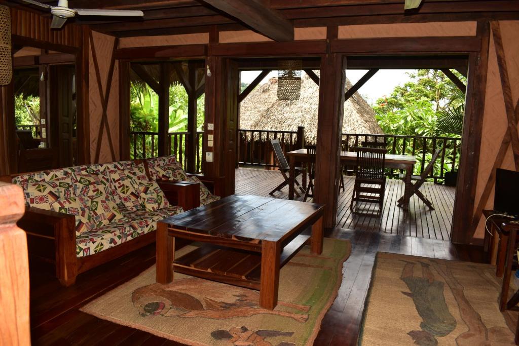 a living room with a couch and a table at LOCAVACATION Les Hauts Manguiers Villa 2 in Nosy Be