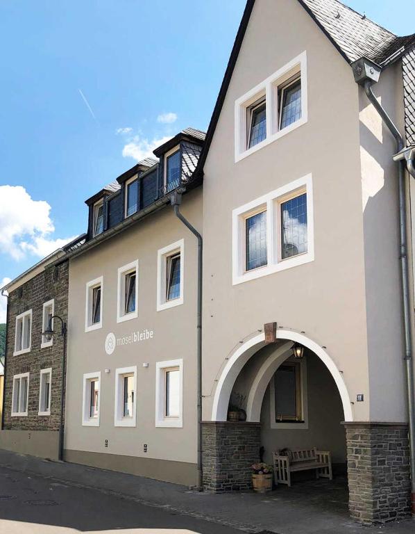 a large white building with an archway at NEU!!! Moselbleibe Winzerhaus Kues in Bernkastel-Kues
