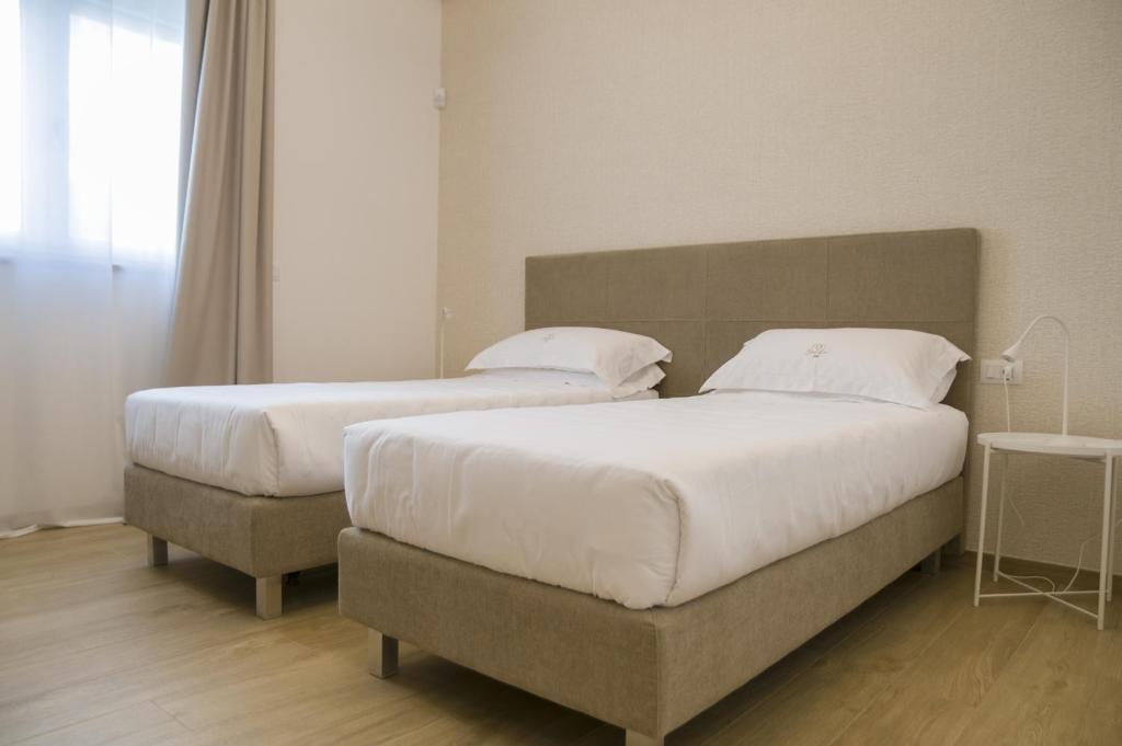 Postel nebo postele na pokoji v ubytování Galileo Suite