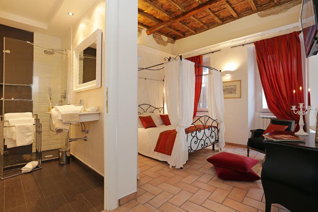 a bedroom with a bed and a bathroom at Madonna de' Monti Suites in Rome