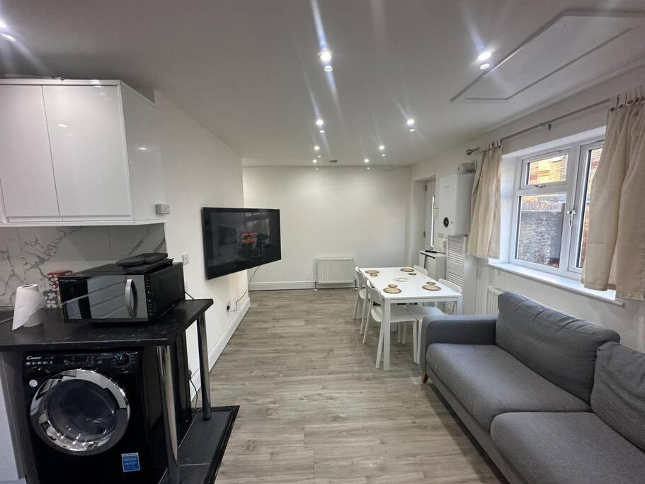 a living room with a couch and a table at 2 Bedroom house,BrownhillRd SE6 in London