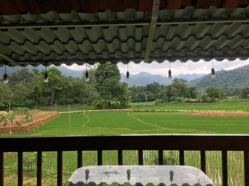 a view of a golf field from a porch at Ha Giang Lake View House in Ha Giang