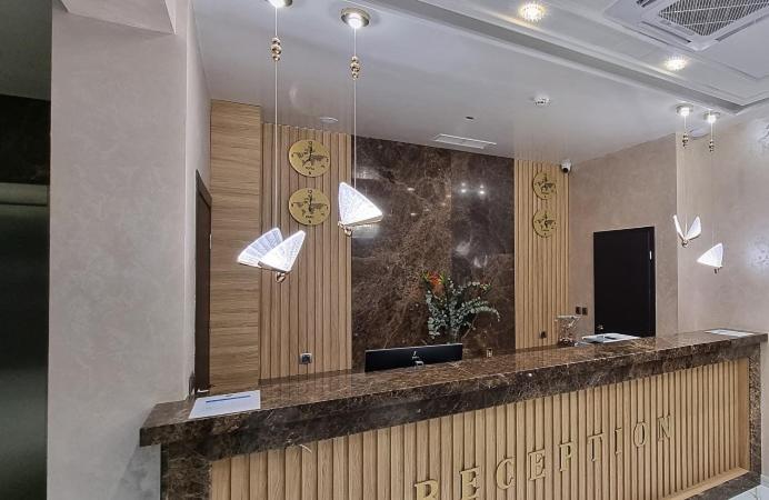 a lobby with a reception counter and lights at Park Hotel Viasport in Gorni Dŭbnik