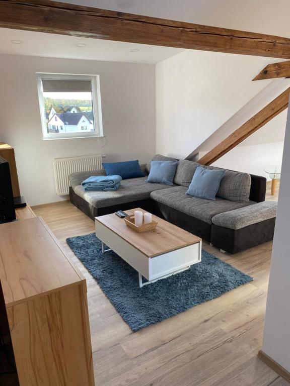 a living room with a couch and a coffee table at Lieblingsplatz an der Lahn in Weinbach