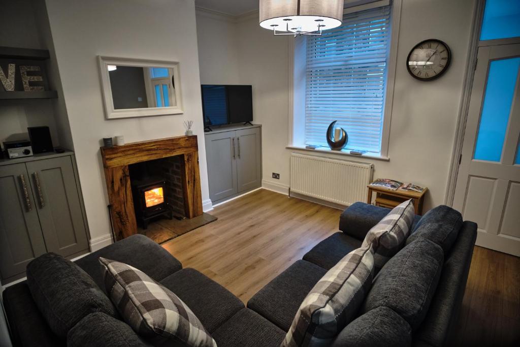 a living room with a couch and a fireplace at Halifax Haven – Simple2let Serviced Apartments in Halifax