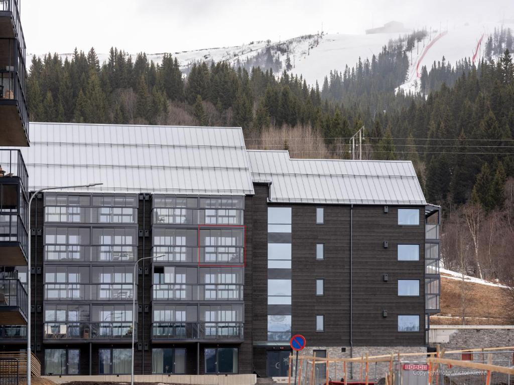 a large building with a mountain in the background at Stunning Apartment in View Are Ski in - VM8 Lift in Åre