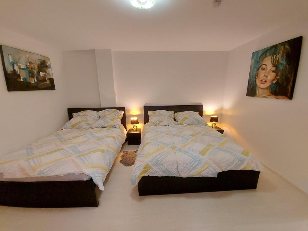 two beds sitting next to each other in a bedroom at 2 modern private rooms with private Balcon fits for 5 persons in Vichten