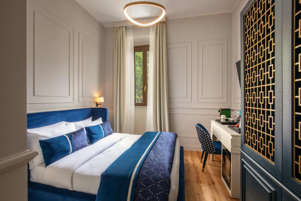 a hotel room with a blue bed and a desk at Navona Sky Palace in Rome