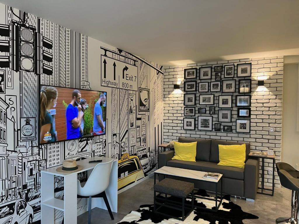 Televízia a/alebo spoločenská miestnosť v ubytovaní Appartement Flandre