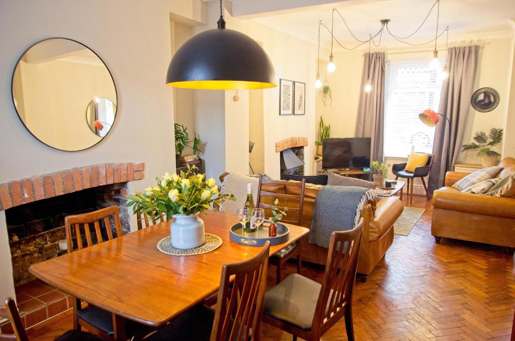 a living room with a dining room table and a couch at Coney Cottage in Porthcawl