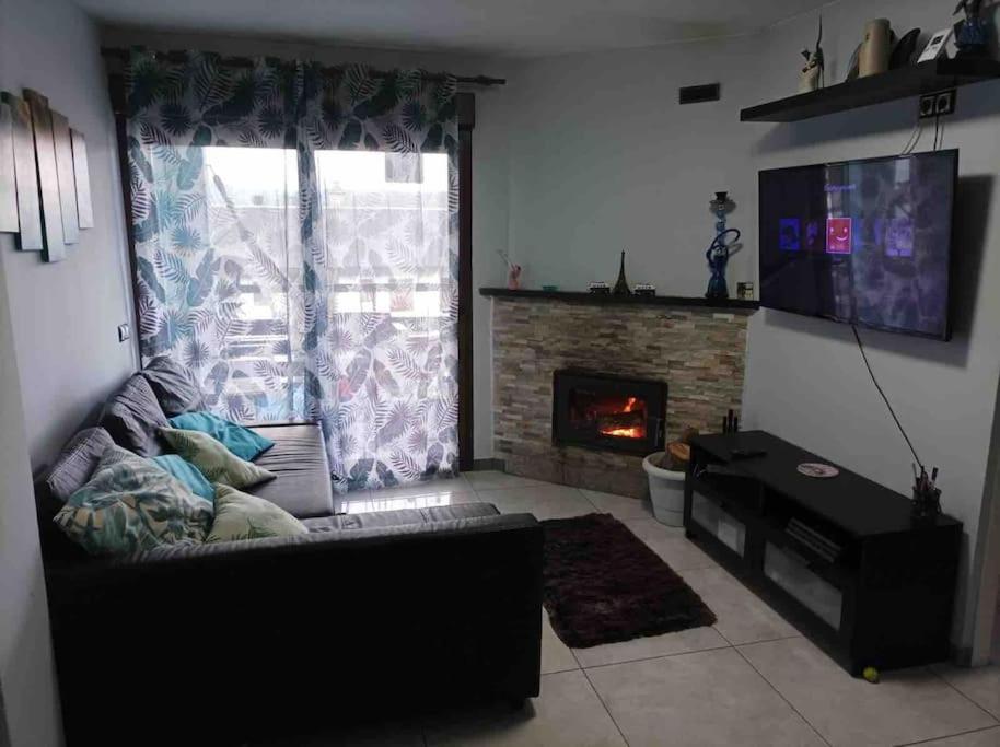 a living room with a couch and a fireplace at Precioso piso en la playa de Madrid a 45 min del centro de la ciudad in Madrid