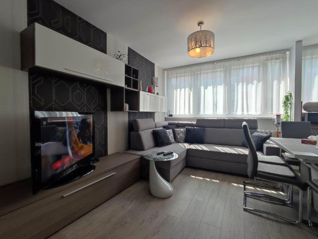 a living room with a couch and a fireplace at Komfortowy Apartament w Kłodzku in Kłodzko