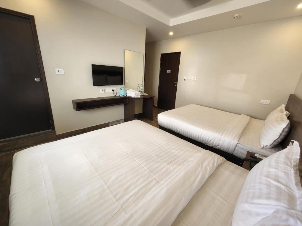 Postel nebo postele na pokoji v ubytování HOTEL PARK KRISHNA