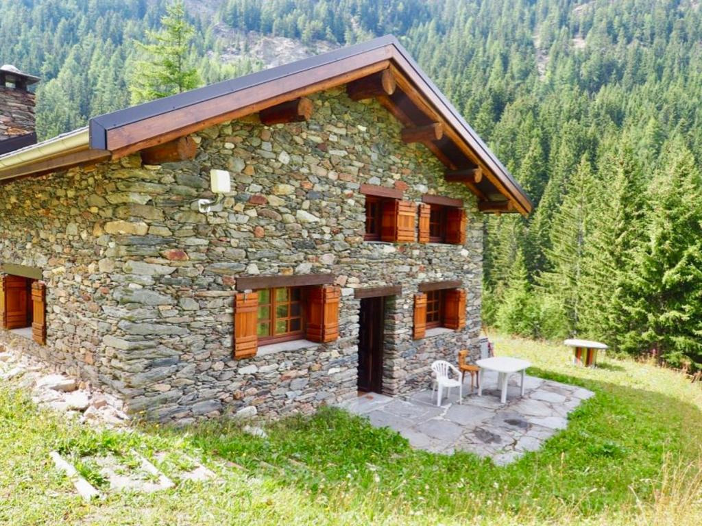 a stone house with a table in front of it at Chalet Valfréjus, 5 pièces, 6 personnes - FR-1-468-39 in Valfréjus