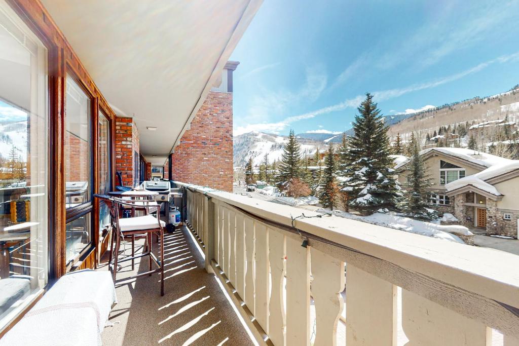 a balcony with a view of the snow covered mountains at The Village Glen in Vail