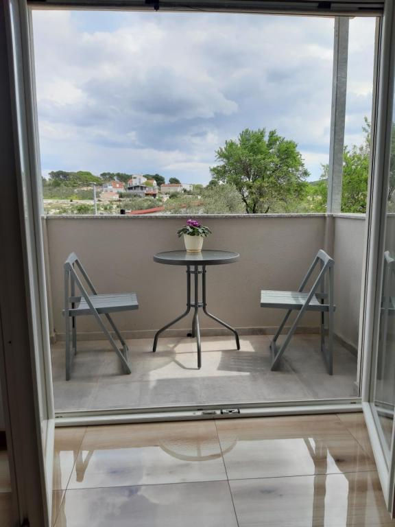 een balkon met een tafel en 2 stoelen bij Apartments Tea and Tamara in Pirovac