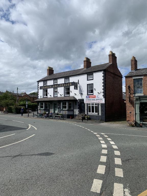 a white building on the side of a street at George & Dragon in Tarvin